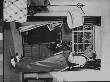 Writer Damon Runyon Trying On Vest With Open Wardrobe Trunk And Other Clothing In Background by Gjon Mili Limited Edition Print