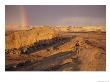 Woman Trail Running In A Rocky Landscape With A Rainbow by Bobby Model Limited Edition Print