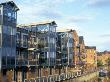 Flats In Restored Wharf Buildings On The River Aire, Leeds, West Yorkshire, England by Brigitte Bott Limited Edition Print