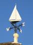 Wind Wheel (Weather Vane) On Top Of A Pub Roof, Harbour, Lymington, Hampshire, England by Brigitte Bott Limited Edition Print