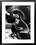 Laborer Tightening Bolt Next To Large Piece Of Machinery by Margaret Bourke-White Limited Edition Print