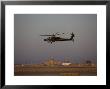 Ah-64 Apache Helicopter Flies By The Control Tower On Camp Speicher by Stocktrek Images Limited Edition Print