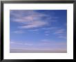 Wispy Clouds Over An Ice-Covered Lake In Alaska by John Eastcott & Yva Momatiuk Limited Edition Print