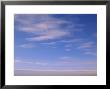 Wispy Clouds Over An Ice-Covered Lake In Alaska by John Eastcott & Yva Momatiuk Limited Edition Print