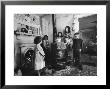 Poverty Stricken Family Huddling Around A Wood Stove In Their Home by John Dominis Limited Edition Print