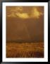 Storm Clouds And A Rainbow Appear Over The Prairie Landscape by Paul Damien Limited Edition Print