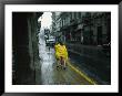 Two People Share A Raincoat As They Hurry Down A Rainy Street by Pablo Corral Vega Limited Edition Pricing Art Print