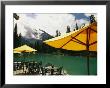 Tables And Umbrellas On The Patio At The Shore Of Emerald Lake by Michael Melford Limited Edition Pricing Art Print