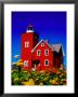 Bright Red Two Harbors Lighthouse With Flowers In Foreground, Lake Superior, Two Harbours, Usa by Richard Cummins Limited Edition Print