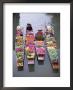 A Group Of Four Women Market Traders In Boats Laden With Fruit And Flowers, Thailand by Gavin Hellier Limited Edition Print