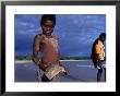 Young Aboriginal Boy With Shovel Nose Fish, Aurukun, Cape York Peninsula, Queensland, Australia by Oliver Strewe Limited Edition Print