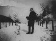 A Well-Dressed Man And His Dog Standing At Attention On A Snow-Covered Path by Wallace G. Levison Limited Edition Print