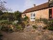 Angles Drystone Wall, Metal Table And Chairs On The Patio At The Back Of The House by Clive Nichols Limited Edition Print