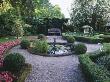 Amsterdam: Private Garden- Box Hedging, Clipped Hollies, Bedding Begonias, And Cupid Water Fountain by Clive Nichols Limited Edition Print