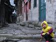 Child Playing On The Street, China by Ryan Ross Limited Edition Pricing Art Print