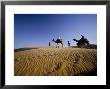 Caravan Of People And Camels In The Thar Desert, Rajasthan State, India by Marco Simoni Limited Edition Print