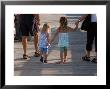 Grandchildren Walk Down A Wooden Pier With Their Grandparents by Stacy Gold Limited Edition Pricing Art Print