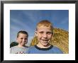 Two Young Kids By A Haybale In Greenleaf, Kansas by Joel Sartore Limited Edition Print
