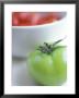 Whole Green Tomato In Front Of A Bowl Of Red Tomatoes by David Loftus Limited Edition Pricing Art Print