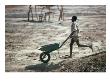 Boy Running With Wheelbarrow, Burkina Faso by Eric Wheater Limited Edition Pricing Art Print