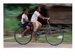 Young Girls Riding Bikes To The Village School In Bavel, Battambang, Cambodia by Jerry Galea Limited Edition Print
