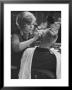 Female Barber Cutting A Customer's Hair In A Barber Shop by Ralph Crane Limited Edition Print