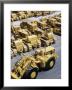 Rows Of Brightly Colored Caterpillar Bulldozers Lined Up At An Unidentified Factory by John Zimmerman Limited Edition Print