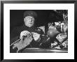 English Cabby Dutifully Knitting Sweater For British Soldier As He Waits At Taxi Rack On Oxford St by Carl Mydans Limited Edition Print