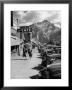 Pedestrians Walking Along Main Street In Resort Town With Cascade Mountain In The Background by Andreas Feininger Limited Edition Print