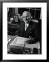 Pres. Harry S. Truman Seated At His Desk In The White House, Family Photographs On Table Behind Him by Gjon Mili Limited Edition Print