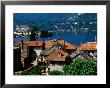 Village Roofs With Lago D'orta And Isola San Giulio In Background, Orta San Giulio, Piedmont, Italy by Glenn Van Der Knijff Limited Edition Print