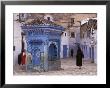 Traditionally Dressed Muslims In The Plaza Alhaouta, Morocco by John & Lisa Merrill Limited Edition Print