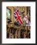 Flags Hanging Outside A Pub, Stow-On-The-Wold, Gloucestershire, England by Glenn Beanland Limited Edition Print