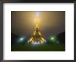 Eiffel Tower Illuminated In Fog And Rain At Night, Paris, France by Jim Zuckerman Limited Edition Print