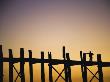 Man Standing On The U Bein Bridge At Sunset In Mandalay, Burma by Scott Stulberg Limited Edition Print