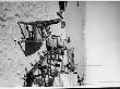 Chinese Nationalist Soldier In Office Chair As He Guards Several Other Wooden Swivel Chairs by Carl Mydans Limited Edition Print