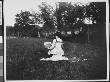 Rear View Of Leticia Brady Working On A Small Painting Of A Wooden Bridge Over A Stream by Wallace G. Levison Limited Edition Print