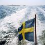 The Swedish Flag On A Ferry Sailing In The Gateborg Archipelago, Sweden by Maria Olsson Limited Edition Print