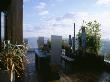 Roof Terrace - Iroko Decking, Zinc-Wrapped Table, Stainless Steel Throne Chairs, Steel Sculpture by Clive Nichols Limited Edition Print