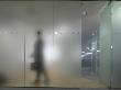 Office Life And Interiors, Glass Partition And Figure Walking Behind It by Richard Bryant Limited Edition Print