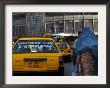 An Afghan Woman Clad In A Burqa Walks Next To A Taxi In Kabul, Afghanistan, Wednesday, June 7, 2006 by Rodrigo Abd Limited Edition Print