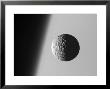 This Amazing Perspective View Captures Battered Moon Mimas Against The Hazy Limb Of Planet Saturn by Stocktrek Images Limited Edition Print