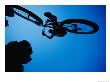 A Mountain Biker Careens In The Air And The Photographer Captures This Dynamic Image From Beneath by Barry Tessman Limited Edition Print
