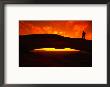Silhouette Of A Hiker On Mesa Arch Against A Spectacular Orange Sky, Utah, Usa by Cheyenne Rouse Limited Edition Pricing Art Print