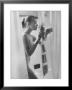 Woman Standing In Bathtub Demonstrating Various Gadgets For The Improvement Of Bathing by Peter Stackpole Limited Edition Pricing Art Print
