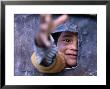 Boy Reaching Through Hole In Gate, Alchi, Jammu And Kashmir, India by Daniel Boag Limited Edition Print