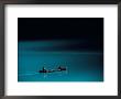 A Canoe Plies The Mirror-Smooth Surface Of Lake Louise by Raymond Gehman Limited Edition Print