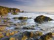 Late Evening Sunlight Glows On Weathered Rock Ledges At Bantham In South Devon, England by Adam Burton Limited Edition Print