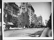Horse-Drawn Carriages Riding Up And Down Fifth Ave. At With 29Th St by Wallace G. Levison Limited Edition Print