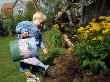 A Little Boy Watering Flowers With A Watering Can by Arnaldur Halldorsson Limited Edition Pricing Art Print